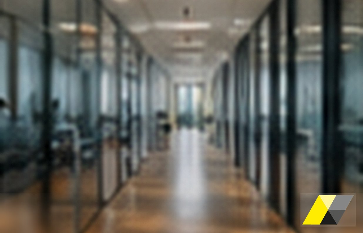 Long office corridor with glass walls: an internal investigation in Italy inside the offices of a subsidiary